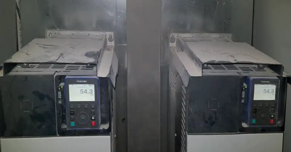 Zwei Toshiba-Frequenzumrichter mit sichtbarer Staubschicht im Schaltschrank – reale Industrieumgebung mit erhöhter Staubbelastung.